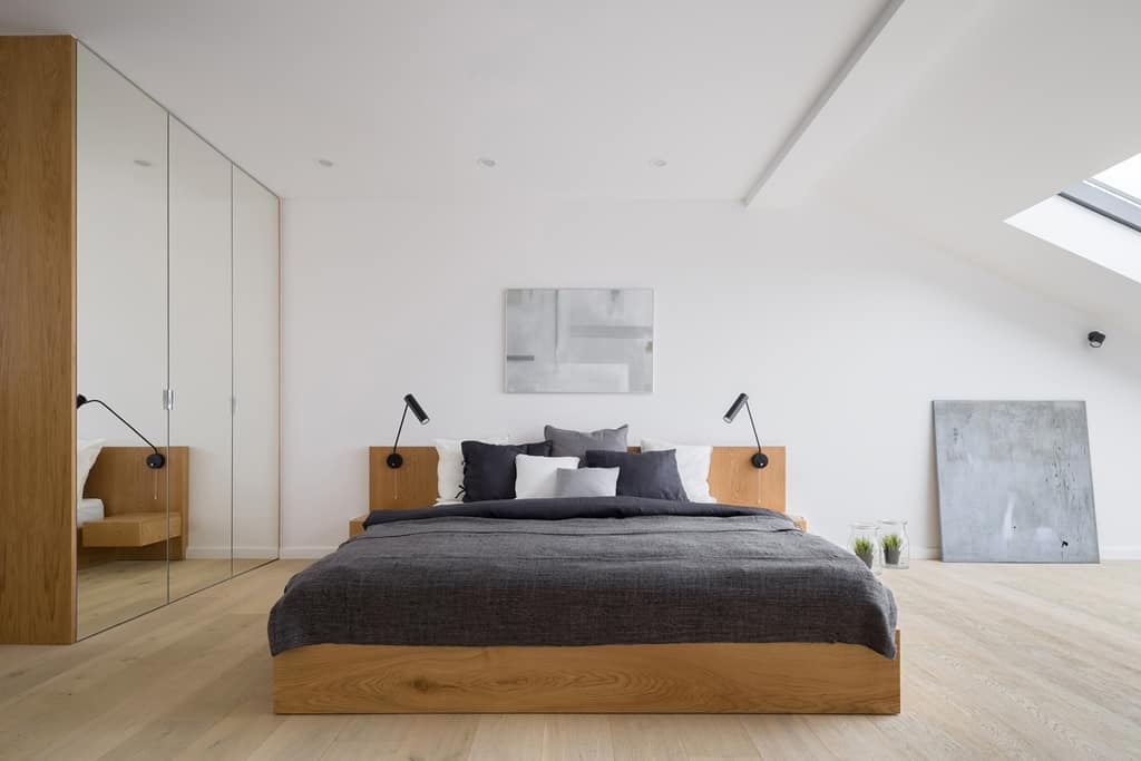 bedroom in a wooden wardrobe with mirrored doors