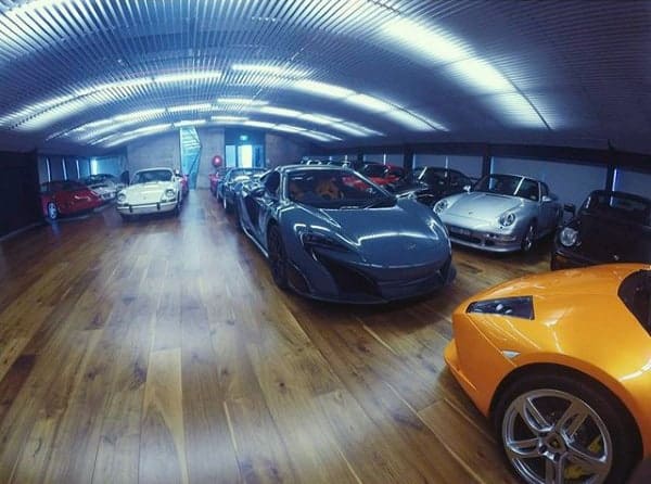 masculine-dream-garage-design-with-wood-flooring-and-exotic-cars