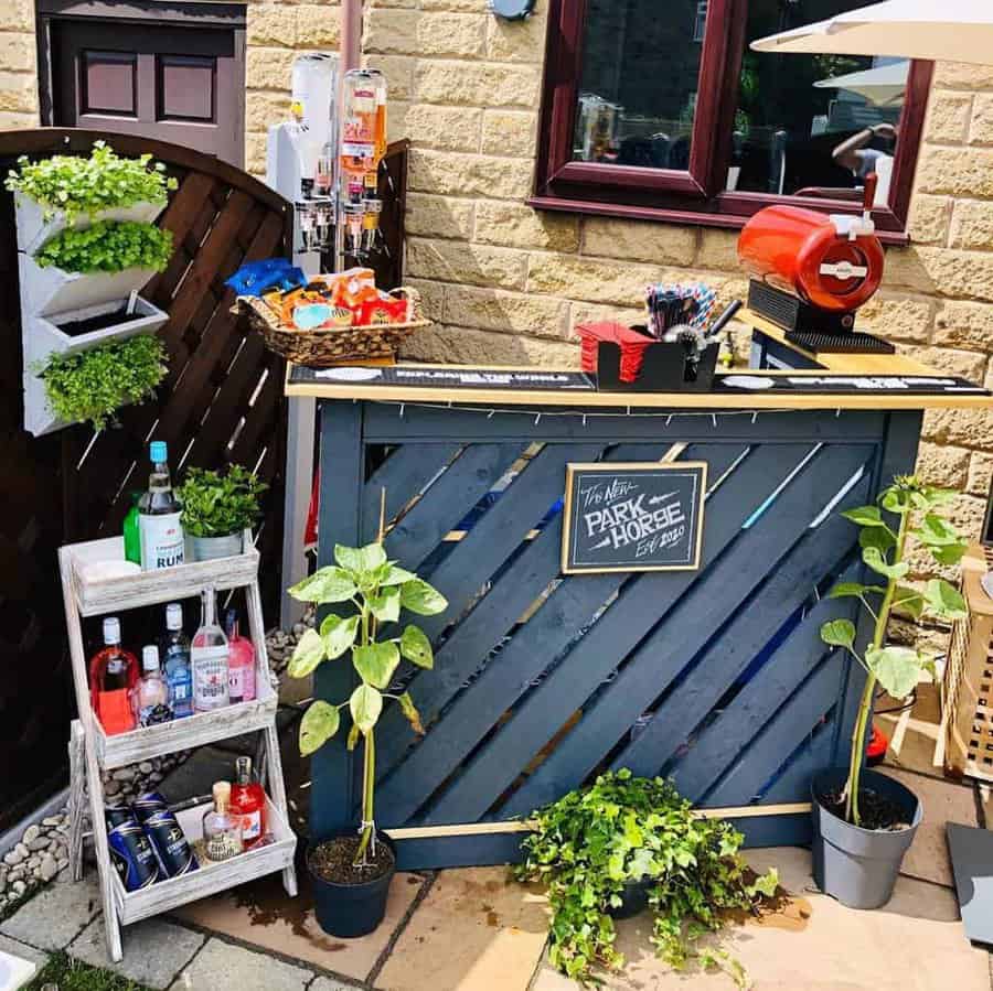 A garden bar with plants and a bottle of wine.