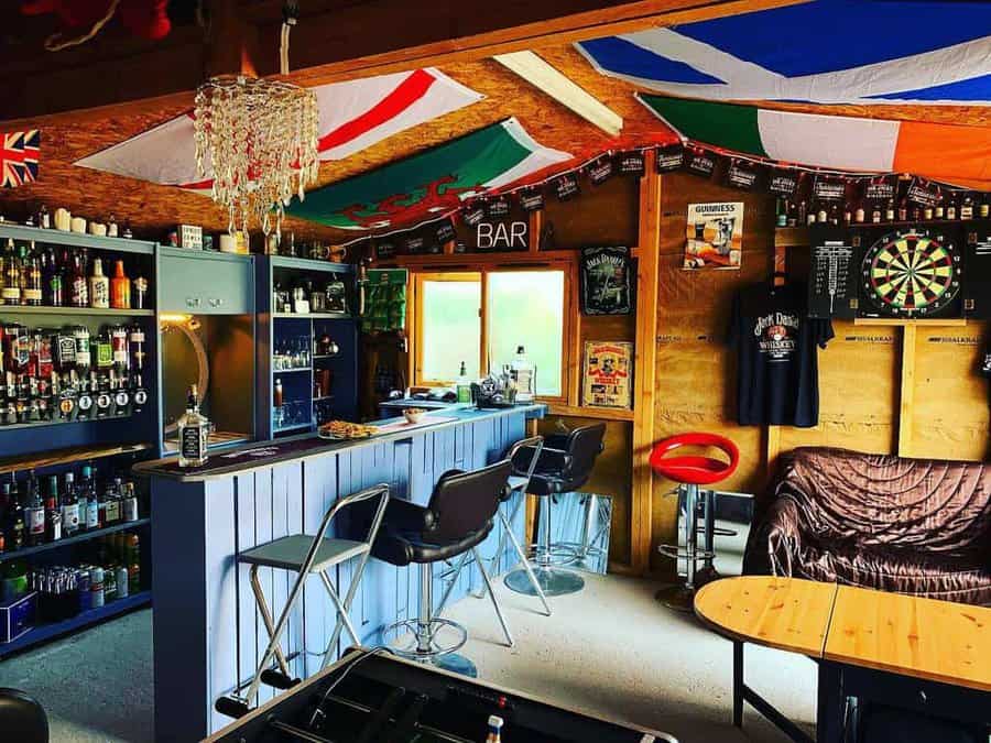 A bar with many different flags hanging from the ceiling.