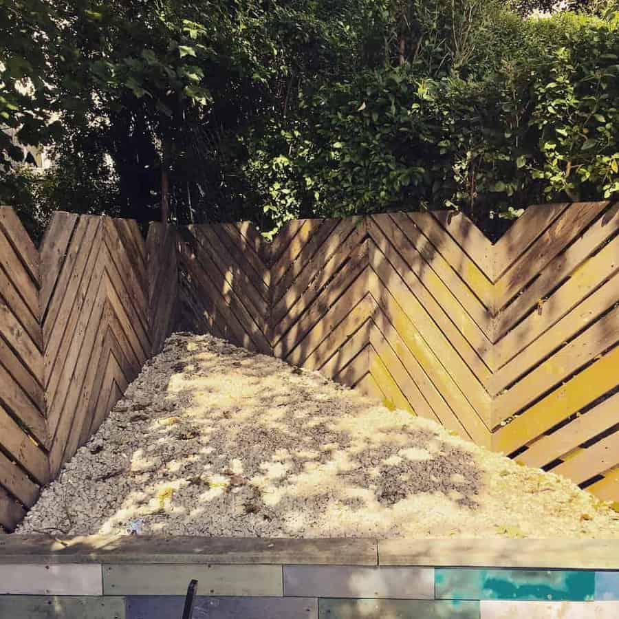 A wooden fence in a backyard with a pool.