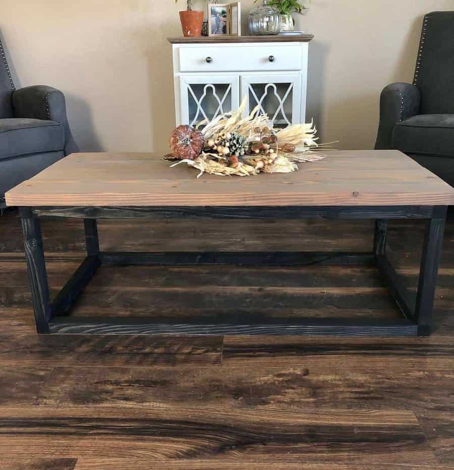 A coffee table in a living room with a metal frame.